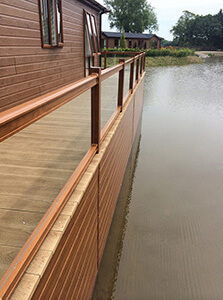 AB Sundecks Picket Glass on raised decking on water overlooking the lake