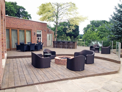 AB Sundecks Decking and Picket Glass in garden surrounding trees with Hot Tub in center